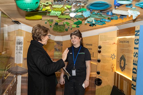 two people talk inside of the trash lab